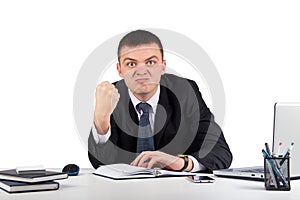 Portrait of a young angry businessman showing you his fist isolated on white background