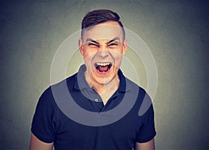Portrait of young angry man screaming
