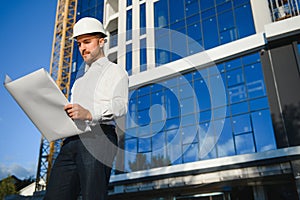 Portrait of a young architect or engineer on a construction site