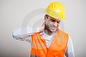 Portrait of young architect holding neck like in pain