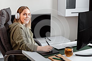 Portrait of Young artist graphic designer. Caucasian blonde woman drawing on graphic tablet by Stylus pen using pc