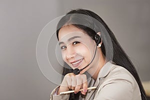 Portrait of young asain girl working at a call center