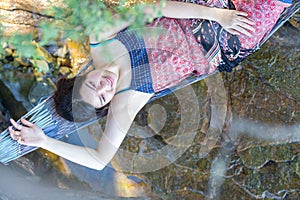 Portrait of young Asia beautiful girl relaxing on hammock on the