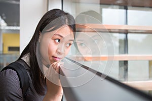 Portrait of a young asia female student in university