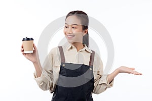 Portrait young asian barista woman wearing apron holding coffee cup and presenting isolated.