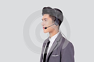 Portrait young asian business man call center wearing headset isolated on white background.