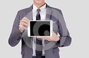 Portrait young asian business man showing and presenting tablet computer with blank with success isolated.