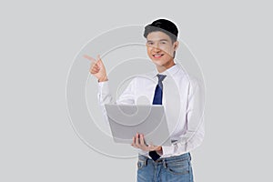 Portrait young asian business man standing work on laptop computer to internet online isolated white background.