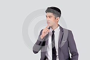 Portrait young asian business man in suit with smart thinking idea isolated on white background.