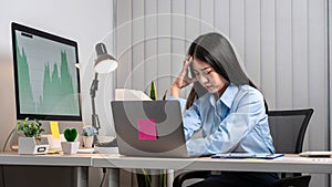 Portrait of young asian business woman feeling stress and tired from work sitting on the chair about constant headaches a migraine