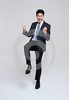 Portrait of young Asian businessman happy and success isolated on studio white background