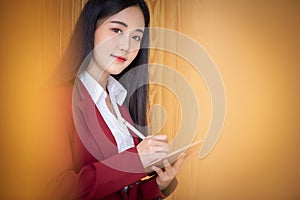 Portrait of Young asian businesswoman using digital tablet in cafe. Business success concept
