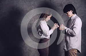 Asian Christian couple holding a crucifix rosary for prayer to God with faithfulness. Jesus Christ christian concept. Portrait
