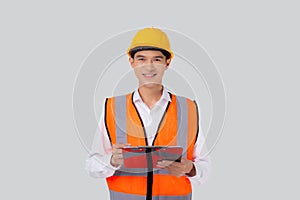 Portrait young asian engineer man wearing helmet looking document or report on clipboard  white background.