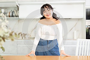 Portrait of young asian girl in the interior of modern kitchen