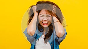 Portrait of young Asian lady with negative expression, excited screaming.