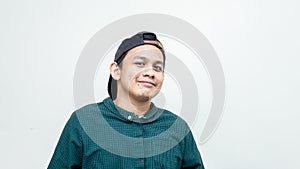 A portrait of young Asian Malay with black cap and casual green shirt