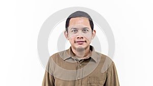 A portrait of young Asian Malay man with brown casual shirt and short hair