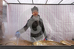 Portrait of a young Asian man cooking at street food stall