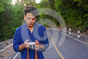 Portrait of young Asian man standing feeling calm