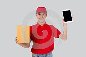Portrait young asian man in uniform standing holding box or package and digital tablet show and presenting.