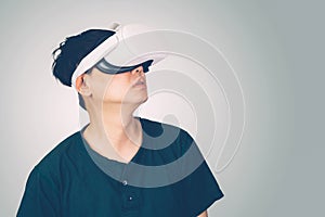 Portrait of young asian man wearing goggles virtual reality with excited isolated on white background.