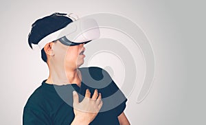 Portrait of young asian man wearing goggles virtual reality with excited isolated on white background.