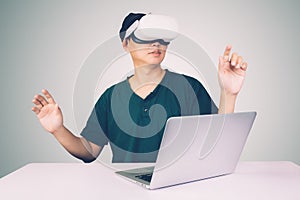 Portrait of young asian man wearing goggles virtual reality with excited isolated on white background.