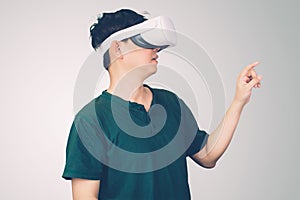 Portrait of young asian man wearing goggles virtual reality with excited isolated on white background.