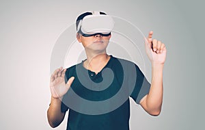 Portrait of young asian man wearing goggles virtual reality with excited isolated on white background.