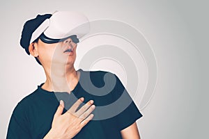 Portrait of young asian man wearing goggles virtual reality with excited isolated on white background.