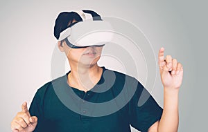 Portrait of young asian man wearing goggles virtual reality with excited isolated on white background.