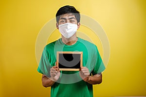 Portrait of young Asian man wearing protective mask against the coronavirus