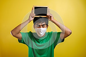 Portrait of young Asian man wearing protective mask against the coronavirus