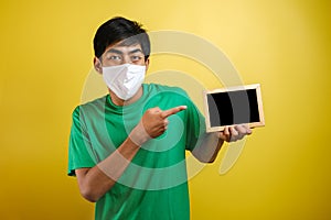 Portrait of young Asian man wearing protective mask against the coronavirus