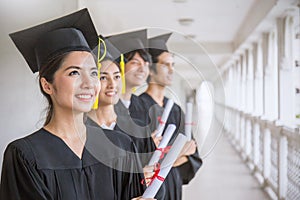 Portrait of young asian man and woman graduates standing in line