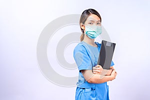 Portrait of young Asian nurse wearing surgical mask holding clipboard