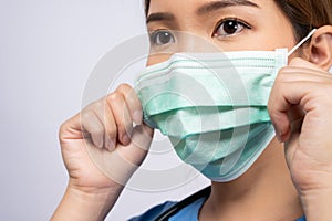 Portrait of young asian nurse wearing surgical mask photo