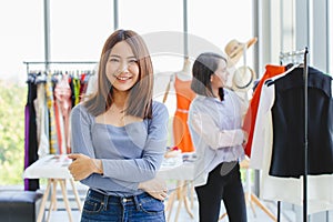 Portrait Young Asian SME Business owner happy smile with her new clothing shop grand opening day promotion and customer care