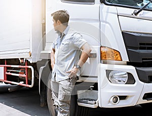 Portrait of young asian a truck driver standing with a truck