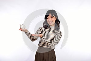 Portrait of young Asian woman casual uniform holding white piggy bank isolated on white background, Financial and bank saving