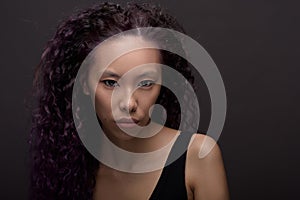 Portrait of young asian woman with curly hair