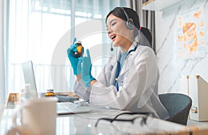 Portrait of young asian woman doctor with white coat standing in hospital.Telemedicine, Medical online, e health concept. Doctor