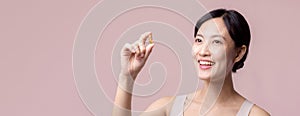 Portrait young asian woman happy smile face with vitamin nourishment pill. Pretty cute girl female person holding health capsule