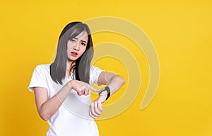 Portrait of young Asian woman holding hand with wrist watch