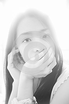 Portrait of young asian woman looked at camera,high key picture style,black and white color picture,soft focus.