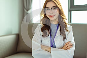 Portrait of  Young Asian woman in medical robe smiling and looking at camera during work .Healthcare concept