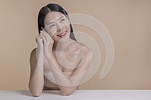 Portrait of a young Asian woman with natural makeup and natural styling. Advertising natural cosmetics