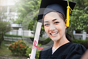 Portrait of young asian woman outside on her graduated day