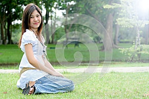 Portrait of a young asian woman in a park